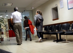 Patients walking through a clinic waiting room