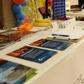 Table of colorful printed materials at the Fort Morgan International Music Festival
