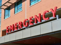Outside view of Hospital with EMERGENCY awning in red