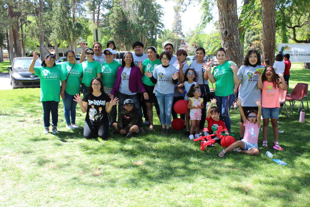 Group of Latiné leaders, wearing Center for Health Progress t-shirts, standing in a park in Pueblo, CO.