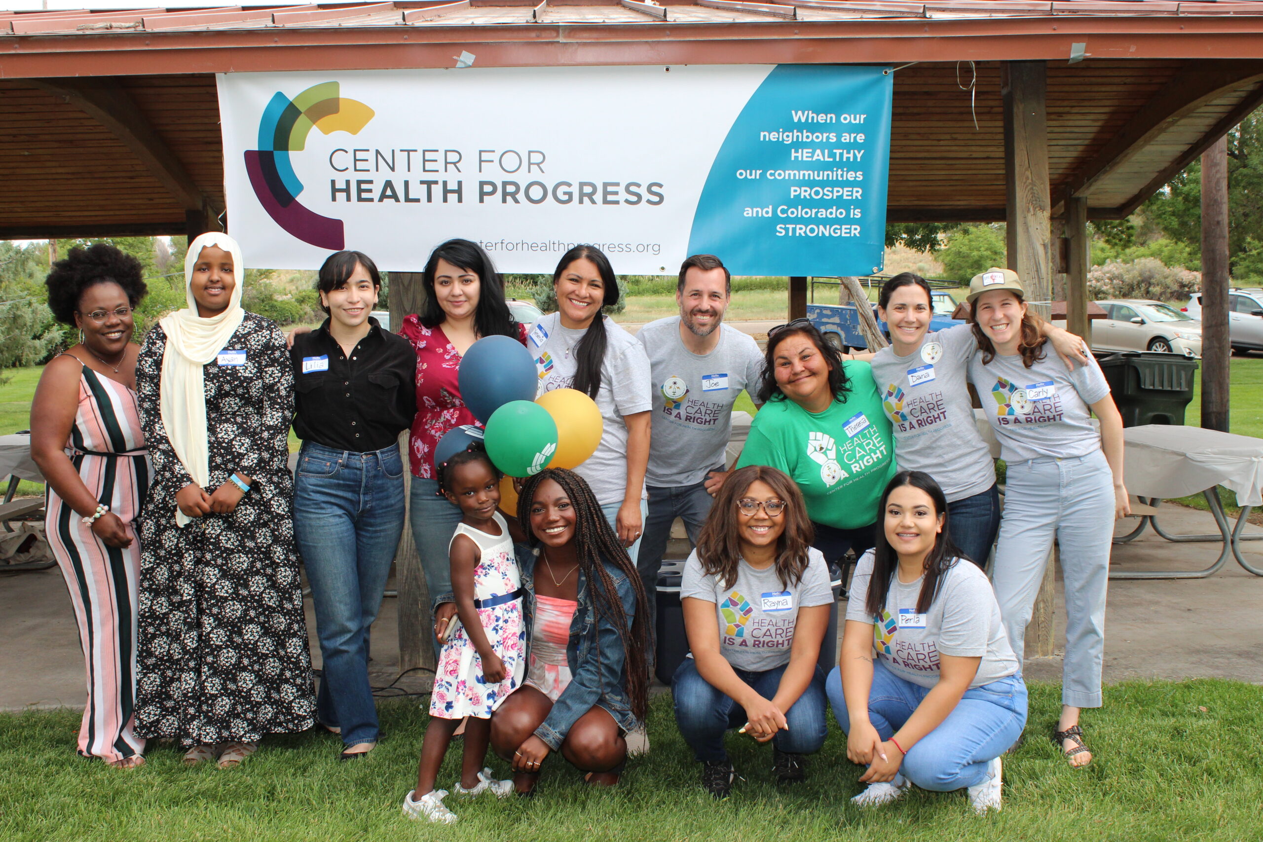 Staff and community gather at a park under Center for Health Progress banner
